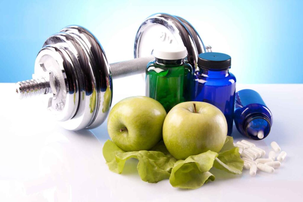 manubrio palestra con mele e integratori sportivi